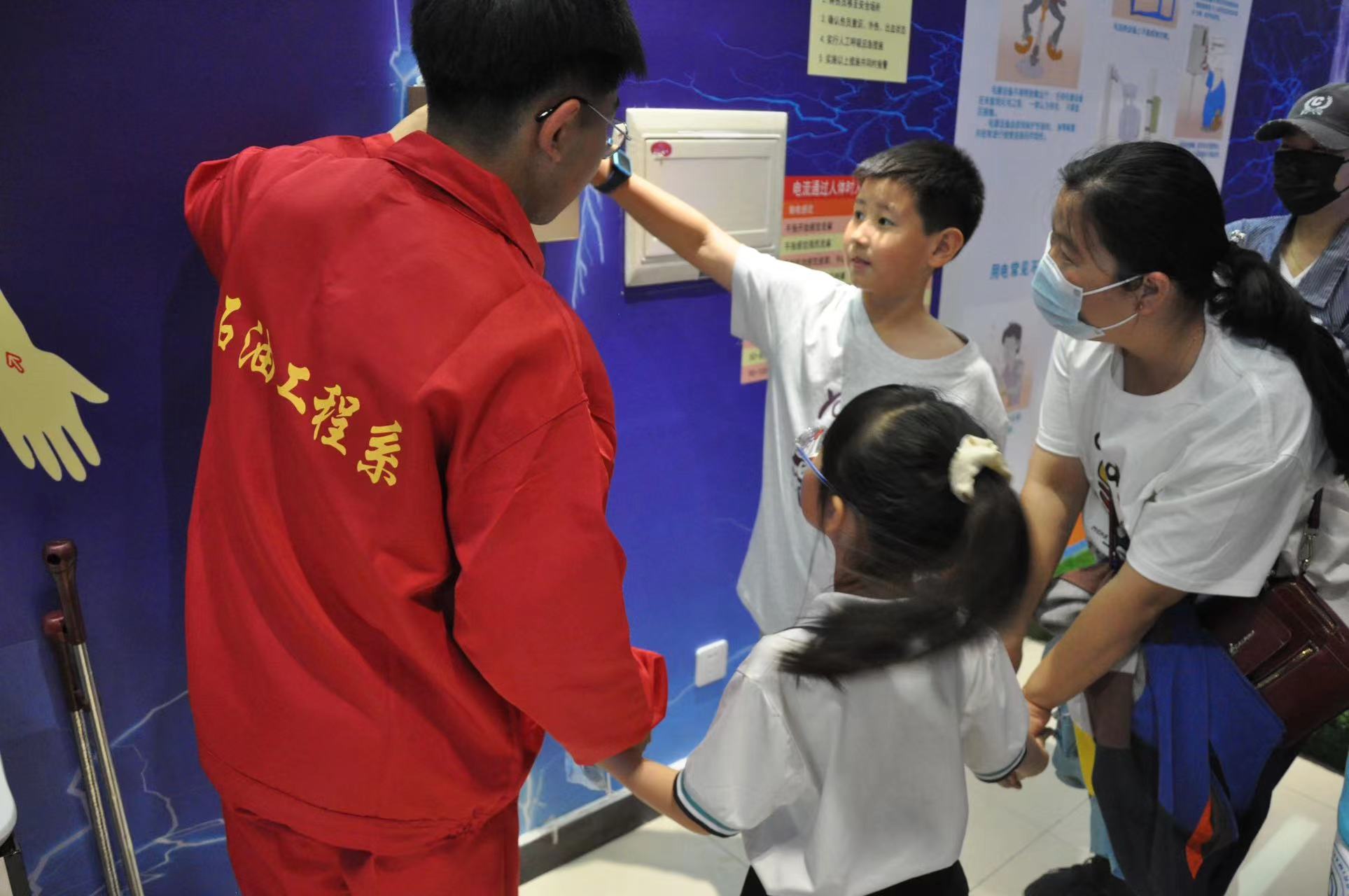 在HSE实验室,志愿者利用安全用电实验设备为小朋友讲解安全用电常识,带领小朋友体验“触电”。